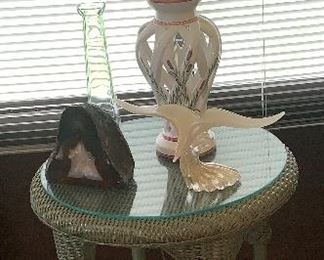 Wicker side table, art glass, polished geode bookends. 