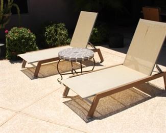 Patio Chaise loungers with a custom moisaic iron table in between