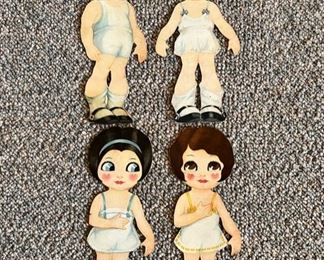 There is a large selection of vintage paper dolls, almost all with several outfits