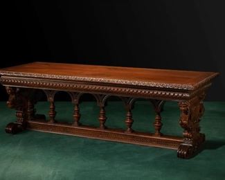 An Italian carved walnut library table