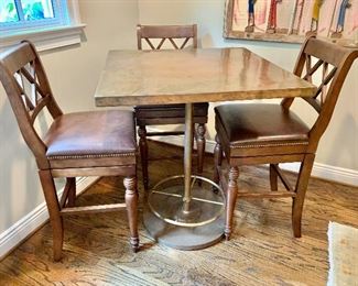 $1,200 -  Gilani Bistro copper/cast iron pub table with foot rest. Table: 41.5" H, 36" W, 36" D.  CHAIRS ARE SOLD
