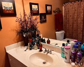 Toiletries, flower arrangement, towels, shower curtain