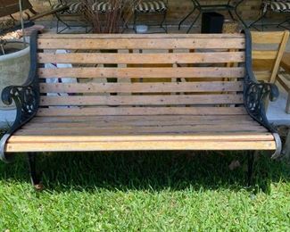Wooden bench with iron arms and legs