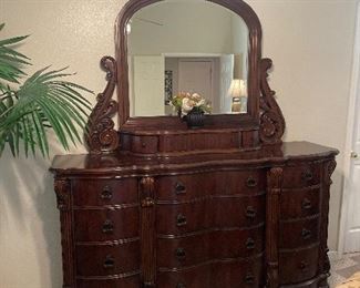 Ashley Collezione Europa 12 drawer mahogany dresser with mirror. Mirror has one drawer with two side hideaway cubby. Mirror is 48” height dresser top 72 inches in length. Dresser: 72 x 16 x 41.5  