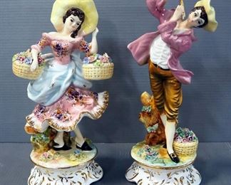Porcelain Figurines Of Woman With Flower Baskets And Man Playing Flute