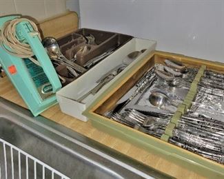 Flatware sets and a vintage turquoise hand mixer
