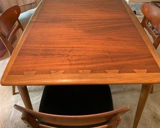 "Acclaim" by Lane Furniture dining table with three 12 inch leaves. Four matching chairs with black vinyl seats. The set is in impeccable condition.