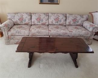 Vintage floral sofa and dark wood coffee table