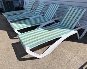 Set of Four Frontage Lounge Chairs in good/used condition with wear consistent with outdoor use. On one of the chairs, the bar that holds the adjustable seat up is cracked. 