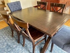 Beautiful set! The pottery barn table measures 60x38x30 inches. It does have a hidden/recessed leaf to provide for additional seating.