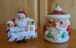 Pair of Christopher Radko Santa Ornaments. Both are in excellent condition. The largest measures 6” high and 4.5” in diameter.