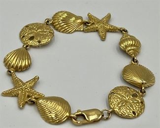 14k Seashell charm bracelet; 7” 

14.93 grams. 