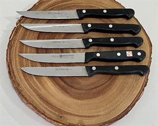 Wooden faux trivet and five Wustof knives in good/used condition. 