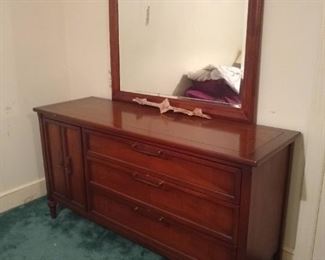 Mirror. This is a buffet that has been used as a dresser. 3 large drawers. On the left there is a door that opens with small pull out drawers designed for flatware but can be used for socks or belts.