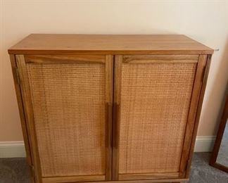 $250 - MCM Style Dresser w/two Caned Doors JR93-20 Inspired by Indonesian handicrafts, this accent cabinet is a modern update that will enhance any room in your home. The beautiful wood-grain surface, paired with natural woven rattan panels provides the perfect balance of materials. This cabinet offers ample storage space as well as a surface for displaying your favorite decorative accessories.                                                     34" x 15" x 34"H