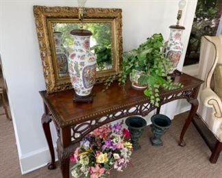 Chippendale style wall table, pair of Asian lamps, cast iron planters below