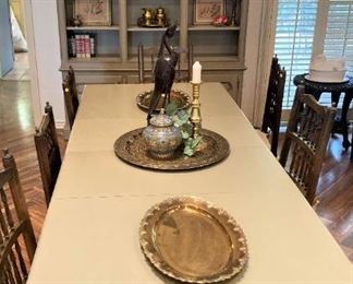This is one of several large dining table. It is pale olive green as is the cabinet in the background. (Several tables have been consigned.)