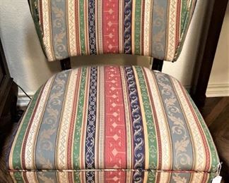 One of two armless chairs