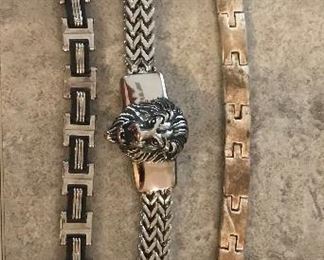 Men's Bracelets and pendant.  Bracelet on the right is 53.3g Sterling Silver and pendant is black onyx and Sterling Silver.  Other two bracelets are stainless steel.