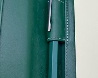 Lot 8804 $250.00 Large Green Leather Rolex Notebook/Portfolio with Original Box and Tissue. The leather is embossed with Rolex Logo, includes: Swiss Made Rolex Pen by Caran D'Ache and Rolex Pad of Paper with Logo. Rare. Suggested Retail is $510.00 	12.5" T x 10" W
