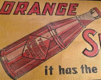 Lot 8786.  $400.00. Vintage Tin and Enameled "Orange Squeeze, It has the real Fruit Juice" Advertising Sign. Measures: 27.75" W x 12.75" T.  The Sign is flexible but all original. Enamel has a leather feel and the Orange Squeeze is embossed in metal.  Very Cool and in great condition,