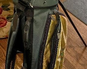 Lot 8783  $250.00  Rare Authentic Master's Carry Golf Bag with Master's Tournament Medallion.  This is the Master's Carry Golf Bag in Master's Green and Gold with Multiple Pockets and in Excellent Condition Like New, Never Used on Golf Course only Display.  Light Weight Carry Bag with Legs.  Could be Men's, Boys or Ladies Bag.  Golf Umbrella is not included (was selling  at our last Estate Sale in May).