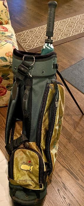 Lot 8783  $250.00  Rare Authentic Master's Carry Golf Bag with Master's Tournament Medallion.  This is the Master's Carry Golf Bag in Master's Green and Gold with Multiple Pockets and in Excellent Condition Like New, Never Used on Golf Course only Display.  Light Weight Carry Bag with Legs.  Could be Men's, Boys or Ladies Bag.  Golf Umbrella is not included (was selling  at our last Estate Sale in May).