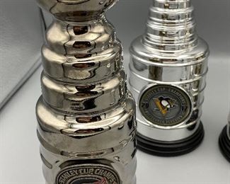 Lot 8811 $110.00 NHL Memorabilia Package, Includes: 2 Stanley Cup Replica Trophies from 2016 and 2017. Stanley Cup Trophy with melted ice, and Red Wing Stanley Cup 2002