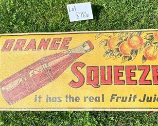 Lot 8786.  $400.00. Vintage Tin and Enameled "Orange Squeeze, It has the real Fruit Juice" Advertising Sign. Measures: 27.75" W x 12.75" T.  The Sign is flexible but all original. Enamel has a leather feel and the Orange Squeeze is embossed in metal.  Very Cool and in great condition,