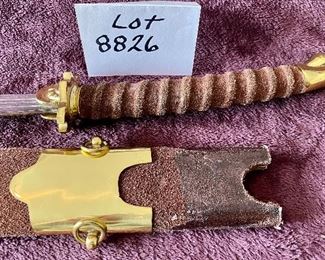 Lot 8826. $95.00 Sword and Sheath.  Leather Grip and Leather Sheath.  Brass Locket and Chape on Sheath.  Brass on Pommel and Cross-Guard. 