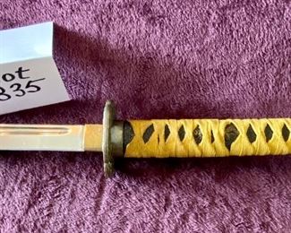 Lot 8835. $60.00. Katana Sword and Sheath. Sheath is made of plastic with Japanese Design.  The Blade is Sharp and Great Condition. Gold Fabric over Pebbled Rubber Grip.  35" L x 1" W Blade