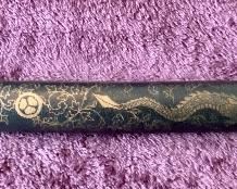 Lot 8835. $60.00. Katana Sword and Sheath. Sheath is made of plastic with Japanese Design.  The Blade is Sharp and Great Condition. Gold Fabric over Pebbled Rubber Grip.  35" L x 1" W Blade