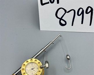 Lot 8799.	$20.00.  Pair of brass desk clocks.  Including a Timex fishing pole and a Howard Miller rotating mini brass clock.  2"h (HM), 4.25" (Timex)	