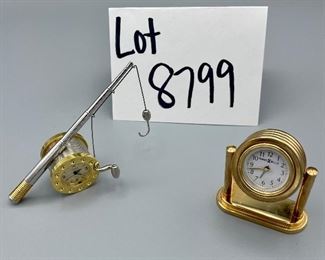 Lot 8799.	$20.00.  Pair of brass desk clocks.  Including a Timex fishing pole and a Howard Miller rotating mini brass clock.  2"h (HM), 4.25" (Timex)	