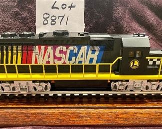 Lot 8871.  $150.00  Lionel O-Gauge 7-11004 Nascar Diesel Engine and Nascar Boxcar 25028 abd Nascar Caboose 36594 3 Rail Train Set.  No Box. 
