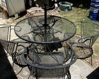 outdoor patio set with umbrella and four chairs