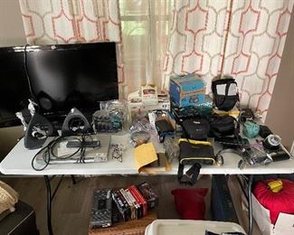 Multiple Media items:  Cameras, Movie Camera, Tape Players, CD Players, Antennas, TV, VHS Tapes, VHS Cases, etc.