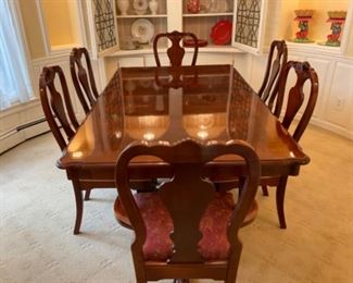 Fruitwood dining table with four side chairs and two captains chairs. Includes two leaves at 20 inches each. Includes pads. Table without leaves 75 inches long