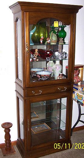 Jasper furniture lighted display cabinet, Hummels, Van Briggle vase, Frankoma pottery, glass paperweights, etc...