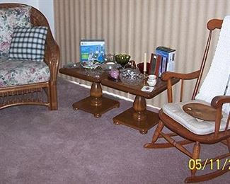 Wicker chair, two of three small pedestal tables, rocker