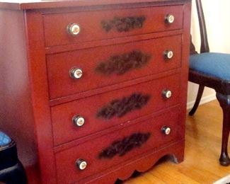 Vintage stenciled chest of drawers in red ochre