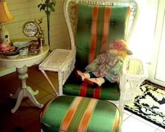 Custom upholstered Henry Link wicker arm chair with ottoman, vintage round lamp table, floor lamp & various collectibles.