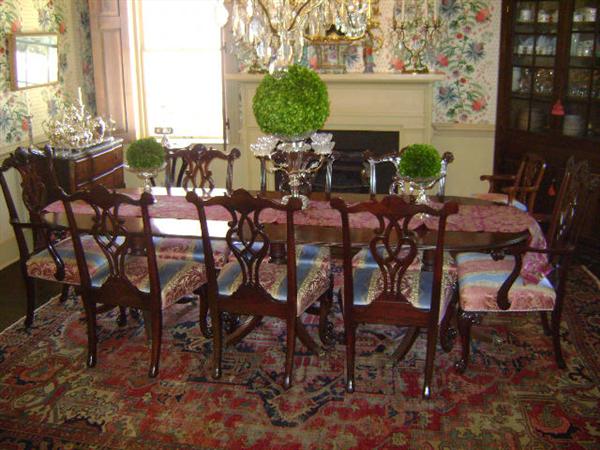 Sheraton dining room table with a set of Chinese Chippendale chairs in Clarence House fabric