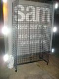 7 foot tall retail or trade show display cage rack with hooks; it rolls, is light-weight, and in good condition, but it will pinch your fingers if you're not careful, ouch!