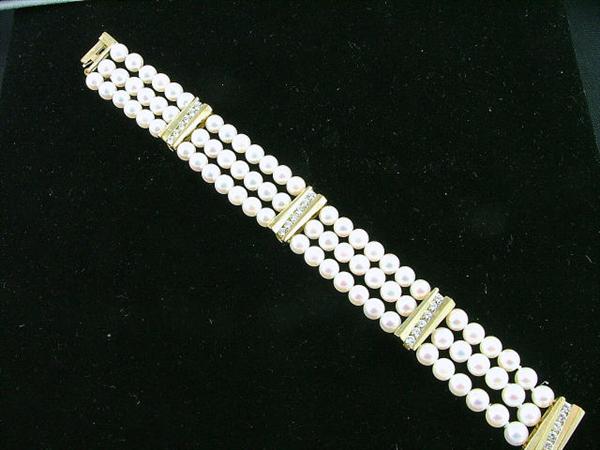 18K gold bracelet with 3 strands of 3mm pearls, diamond clasps.