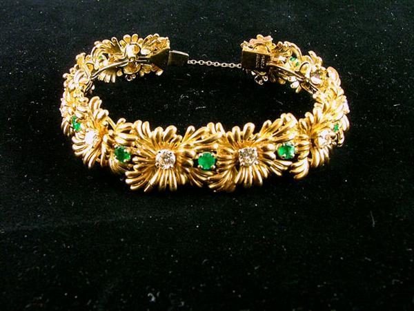 18K gold flower bracelet laced with 2.5 carots of diamonds & 2 carots of emeralds.