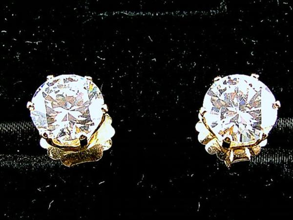 2.5 carat diamonds for each ear! mounted on 18k gold sets.