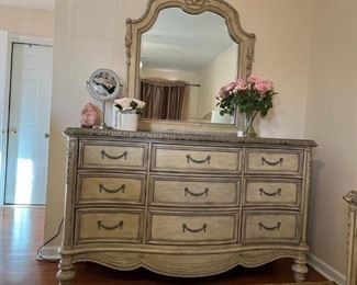 Empire BED ROOM SET - one night stand, mirror, dresser, queen size bed, chest- All 5 pieces. Hard to get collection with this quality. You may notice some ware and tear if any. 
Description of mirror and dresser: 
Empire Il's dresser has nine drawers with a jewelry tray in the top left drawer. Featuring a marble edge and plenty of room for storage. Measurements: DresserLength:
68"Width: 21"Height: 40"MirrorLength: 42"Width:
Height: 46" If you've been waiting for a fresh, new interpretation of luxurious OldWorld styling, you're in luck. That's because when the design calls for an infusion of European inspiration, Empire I lets you fill your home with authenticity and elegance.Crafted with cherry veneers
and carefully finished in two versatile anddécor-friendly colors, this collection is a work of art. On the lighter side, there's a rich Parchment finish that's aged with crackle accents and tippedin silver highlights. 