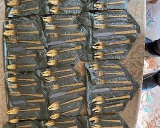 Supreme Cutlery Company (SCC) as marked on the certificate which registered trademark of Syratech which is part of the Towle Silversmiths and it is now part of the lifetime Brands Company.

You may notice minor wear if any that’s because of the long time storage. 

This vintage “BrandNew” product of 1960s or 1970s era. This supreme Vermai flatware electroplated in 23 Karat gold over stainless steel with overall weight of 10lb 3.6 once with the box.