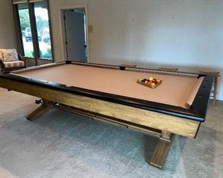 Pool table with mid century modern flair, tan felt and set of balls. $895